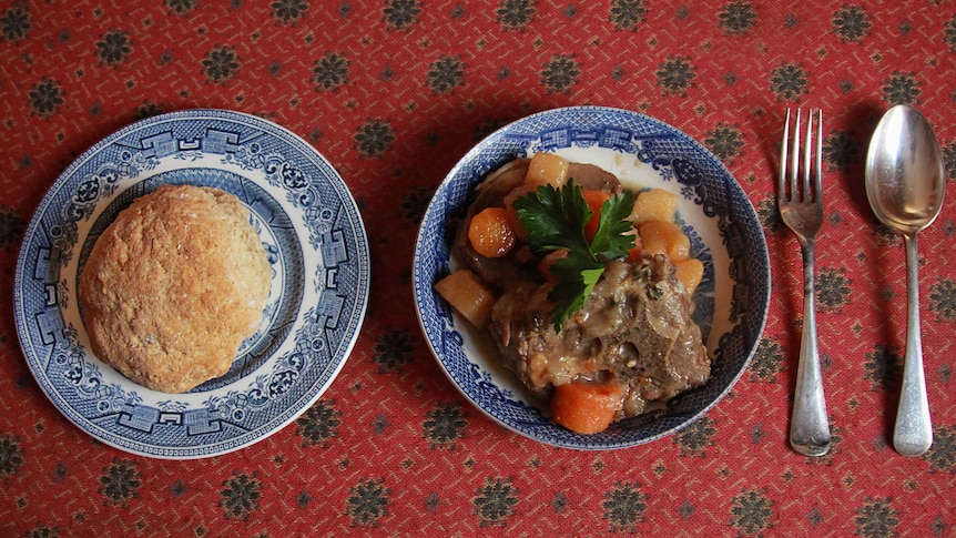 Haricot Mutton stew (pictured with lamb), and Irish soda bread on a read table cloth.