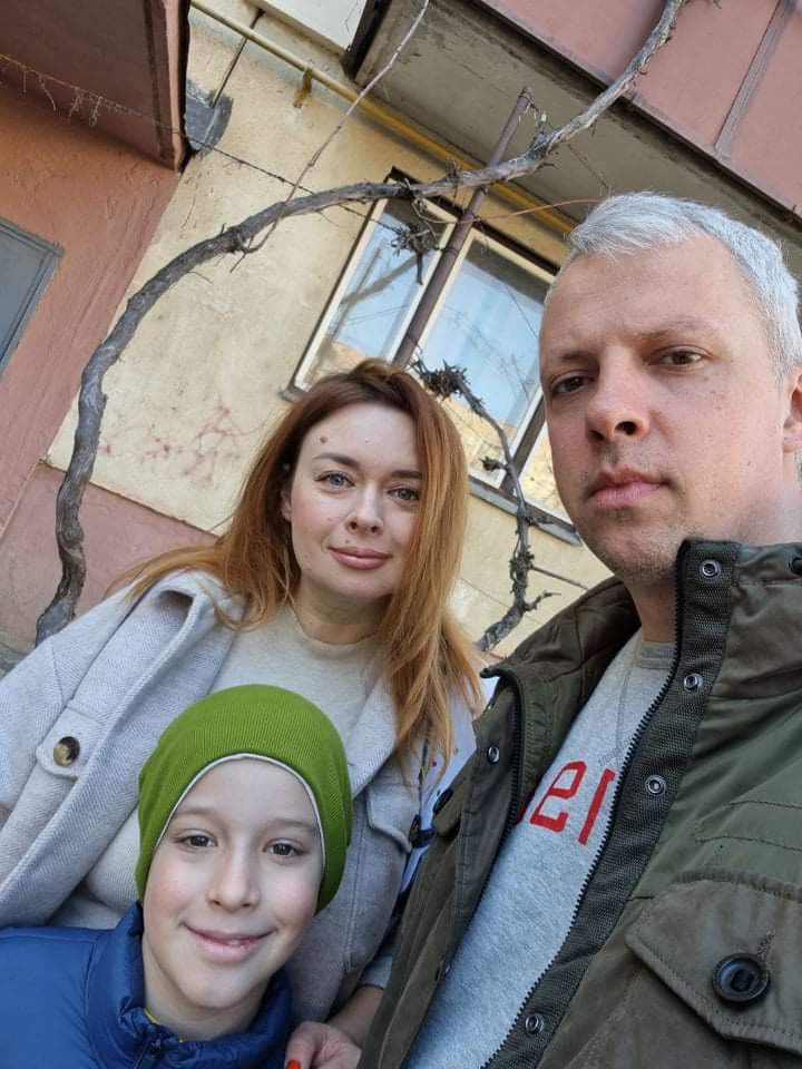 A selfie photo of a woman, man and young boy. 