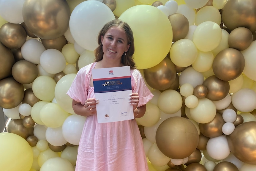 A girl holds a certificate