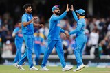 The Indian captain high-fives one of his teammates after a Cricket World Cup match.