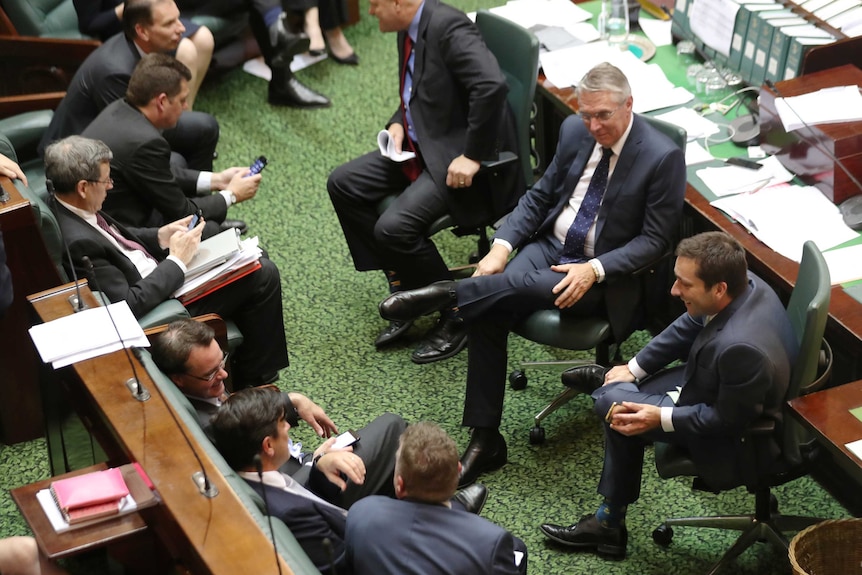 Opposition Leader Matthew Guy talks with Liberal MPs during the debate on voluntary assisted dying.