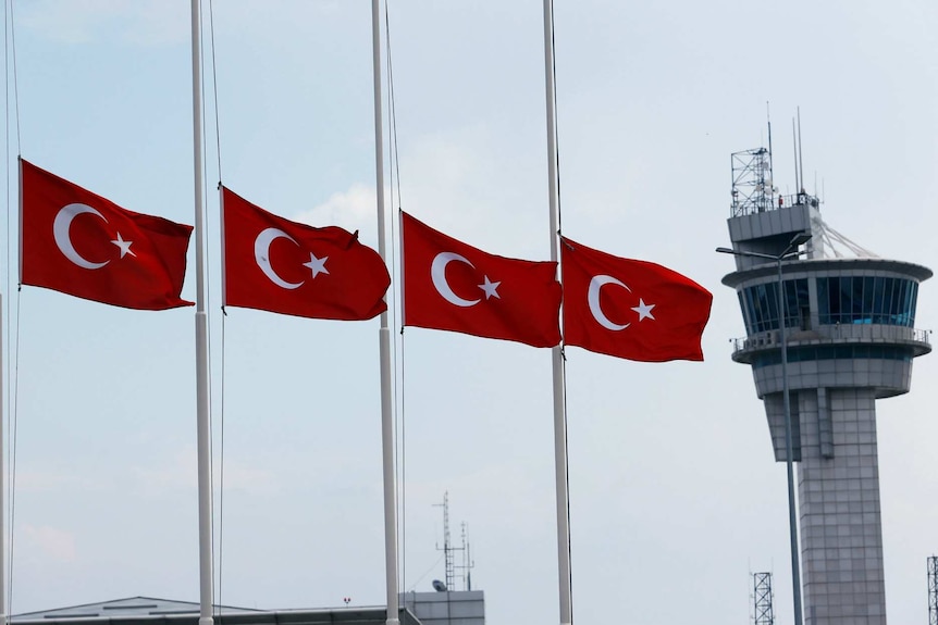 Four flags at the airport at half mast