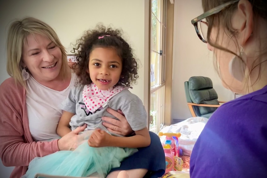 Abigail and mum Mary Lishomwa reading a story