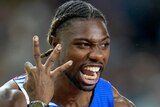 American sprinter Noah Lyles holds up three fingers and yells after a race at the athletics world championships.