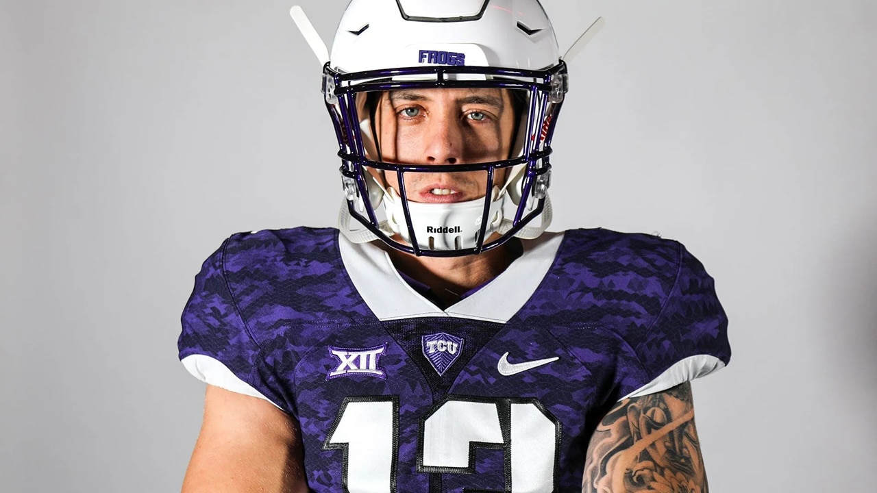 American football player wearing gear staring into camera lens.