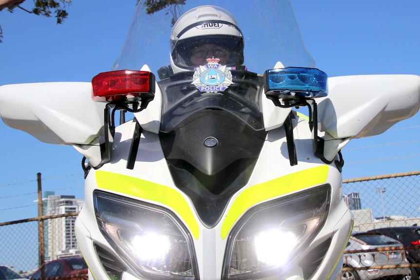 A police officer sits on a motorcycle in East Perth.