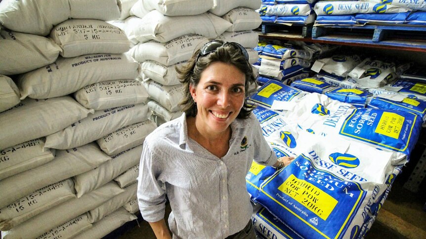 Kalyn Fletcher standing in front of seed bags at her family farm in Kununurra, Western Australia.