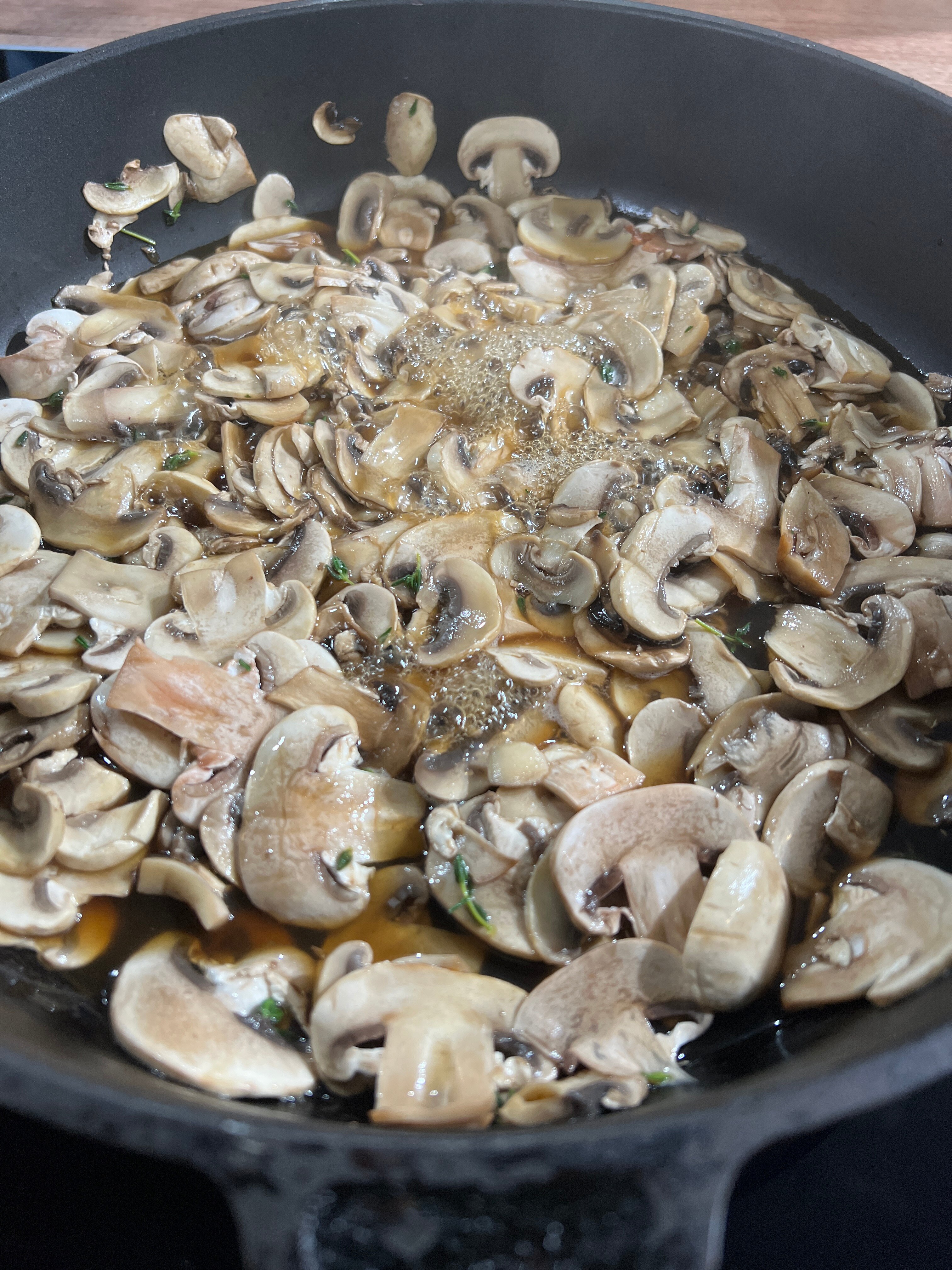 Mushrooms wet-frying in a pan
