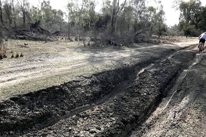 Deep tracks left in muddy ground from car and motorbike tyres