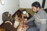 A wounded girl sits near her relatives in Baba Amro, a neighbourhood of Homs, after the recent attacks.