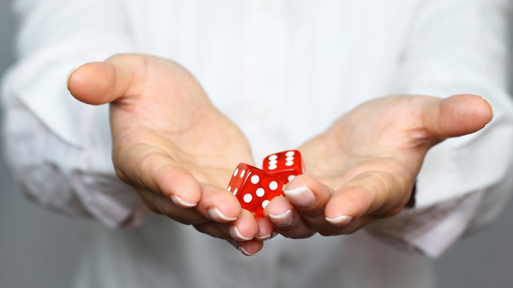 Someone holding a pair of dice in their hands
