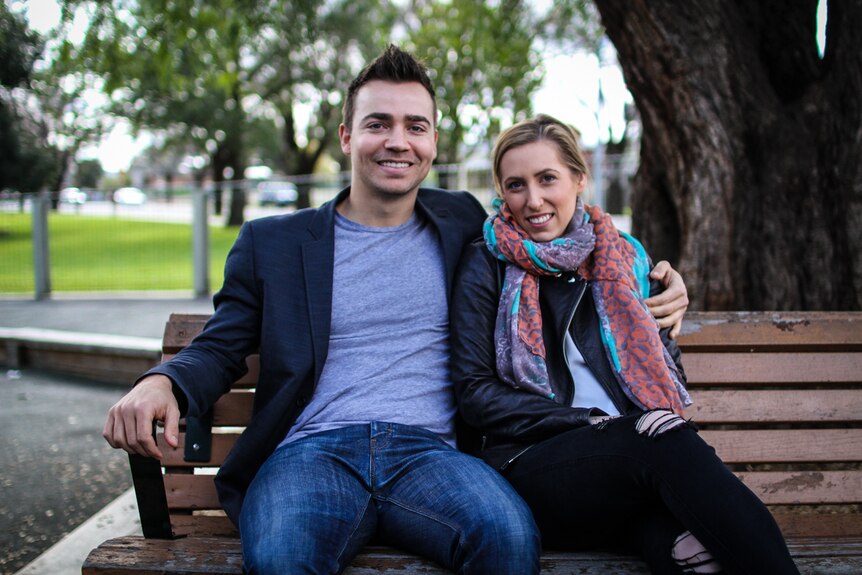 Eat Up founder Lyndon Galea has his arm around his girlfriend Belinda Luke sitting on  park bench.