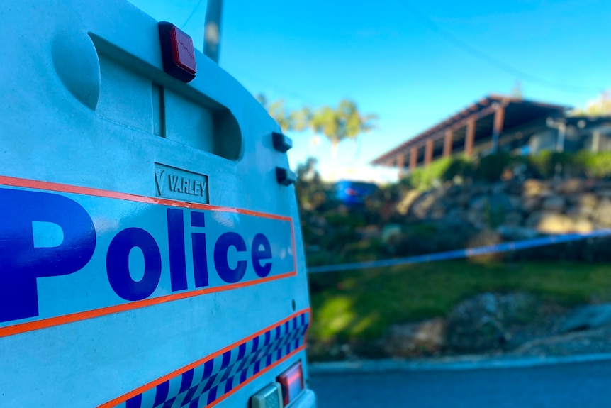 a close-up of the back of a police car parked on a suburban street