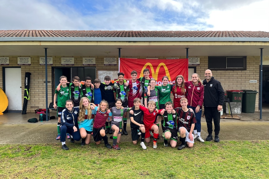 A group photo of young children in soccer kits.