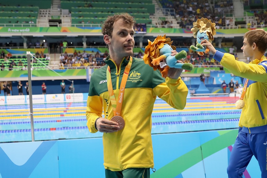 Matthew Levy waves to the crowd after a medal ceremony at the Paralympics.