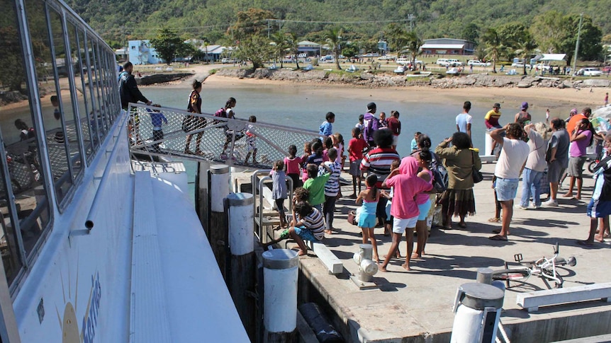Crowds gather for a ferry docking at Palm Island