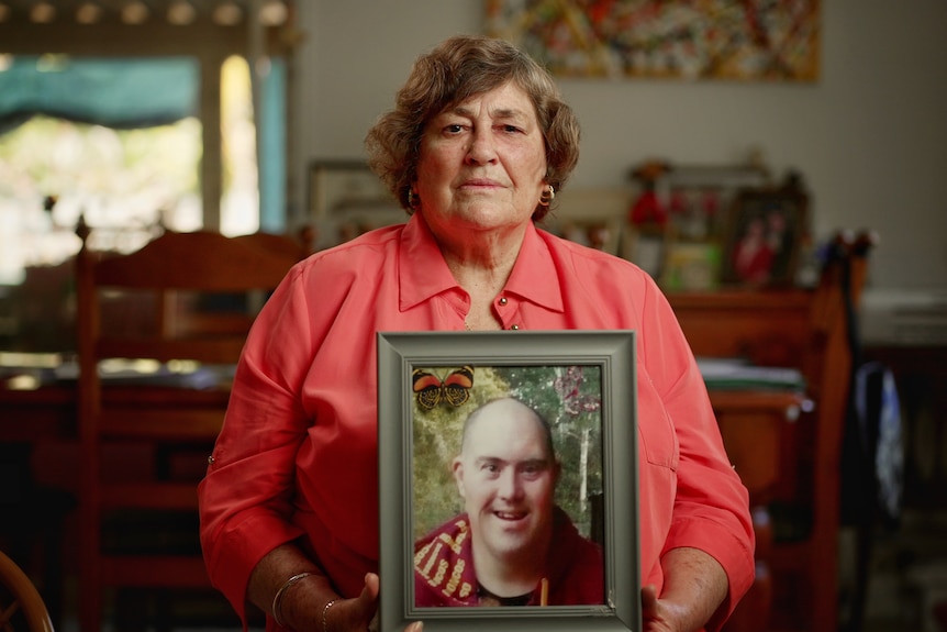 Robyn Tremble holding a photo of her son