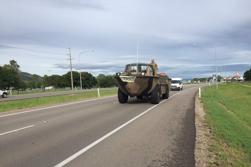 an oversize Army duck vehicle leaves Townsville, heading south to cyclone-damaged communities.