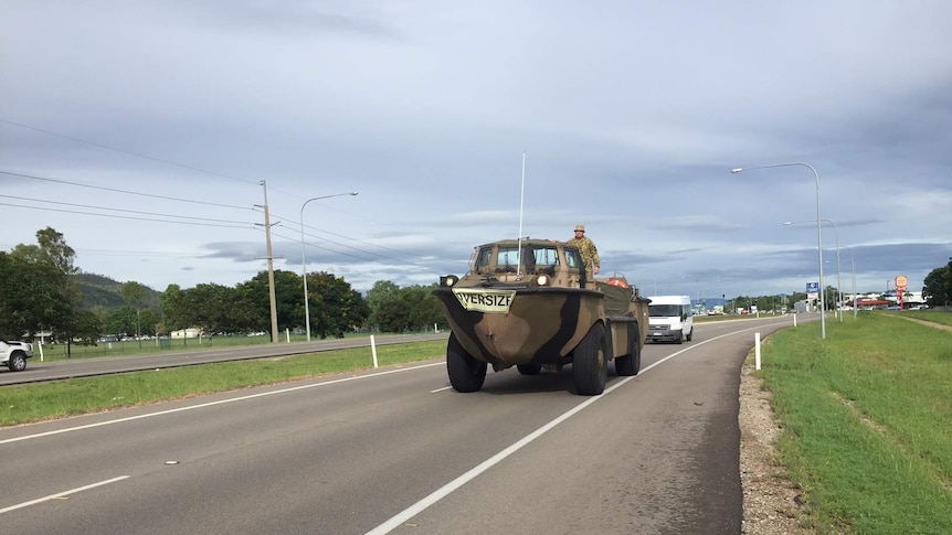 an oversize Army duck vehicle leaves Townsville, heading south to cyclone-damaged communities.
