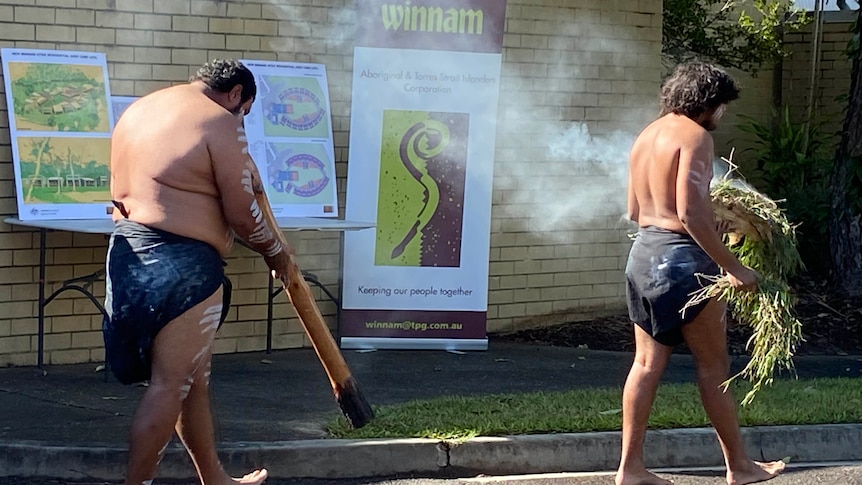 two men partaking in a smoking ceremony