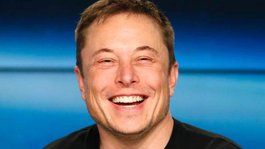 SpaceX founder Elon Musk smiles at a press conference.