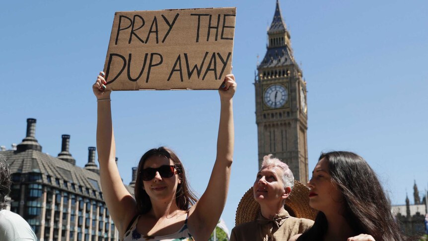 People demonstrate in Parliament Square against the Conservative and DUP coalition government.