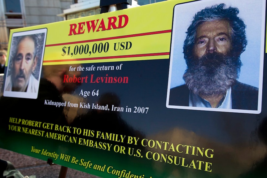 A sign with Robert Levinson showing reward money if he was found.