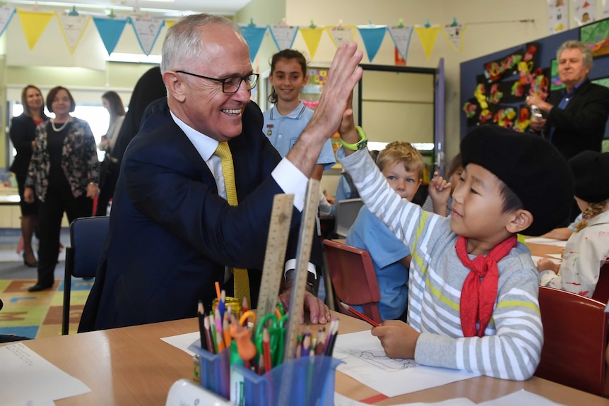Prime Minister Malcolm Turnbull high-fives school student