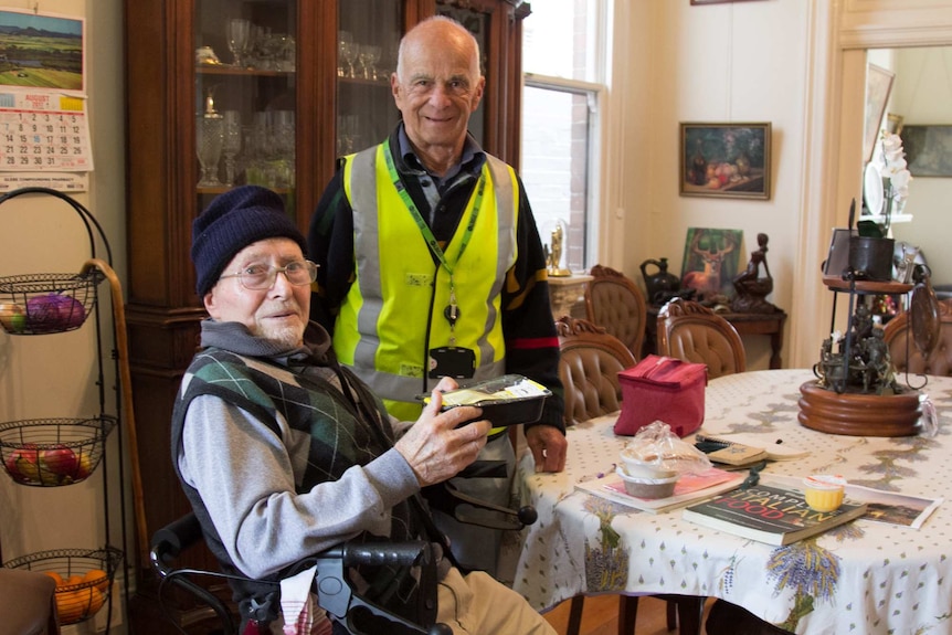 Meals on Wheels volunteer John Karlick with Glebe resident Sergio Ferrari