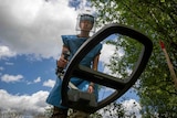 Anastasiia Minchukova sweeps with a mine detector during a training session.