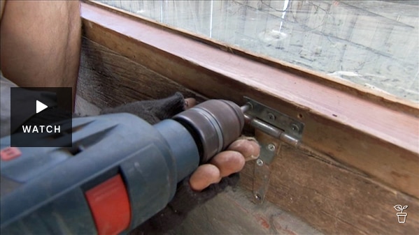 Person using a drill to screw hinges on a lid. Has Video