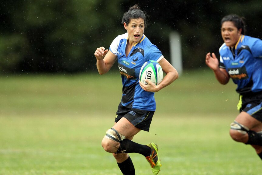 Western Force women's team player Natasha Haines runs with a ball in her hand during training.