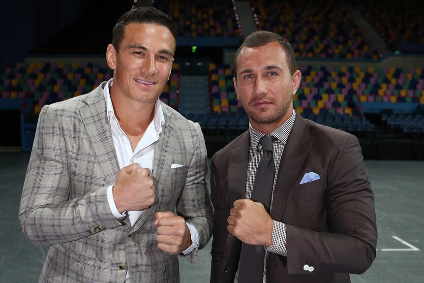 Quade Cooper (R) says he is putting his rugby union career on hold to focus on boxing.