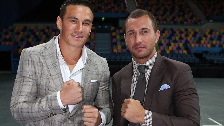 Quade Cooper (R) says he is putting his rugby union career on hold to focus on boxing.