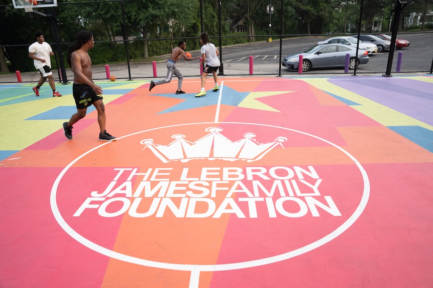 A LeBron Family Foundation logo on a basketball court.