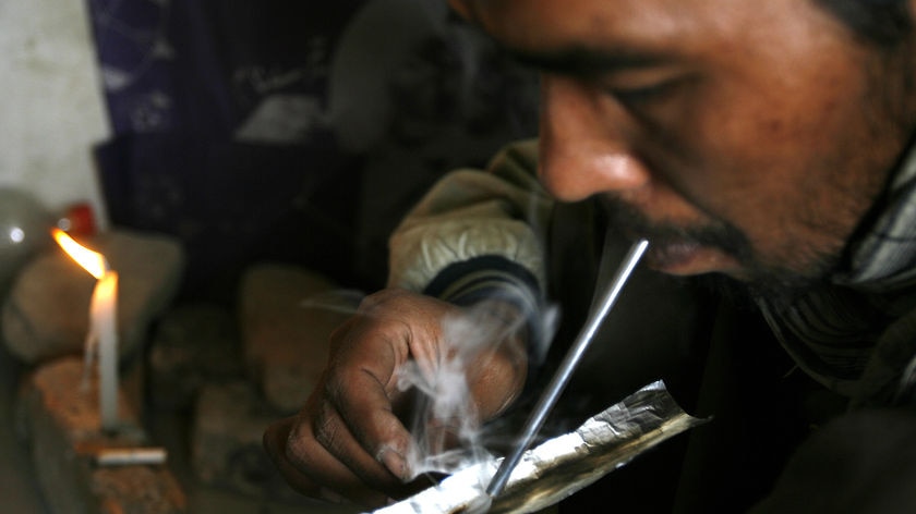 Afghan drug addict smokes heroin