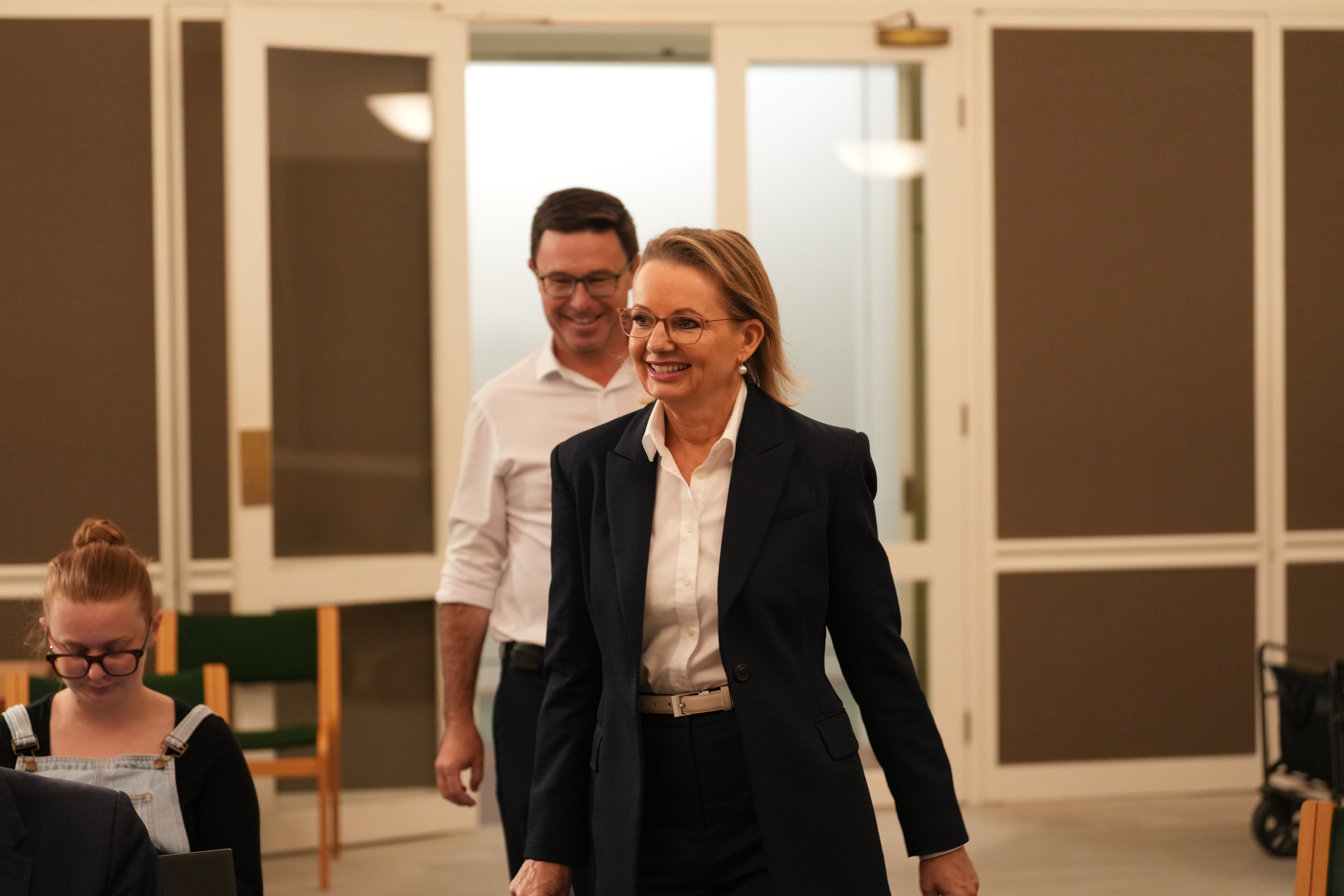 A smiling Sussan Ley and David Littleproud walk into a press conference.