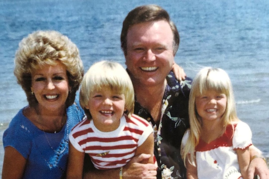 Patti and Bert Newton smiling in a photo with their two young children.