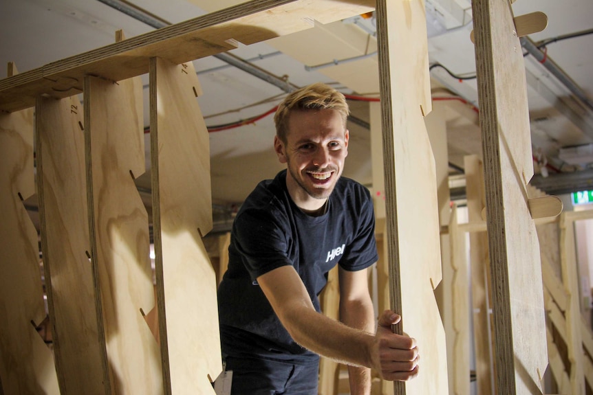 Architect Thomas Wing-Evans inside the wooden structure.