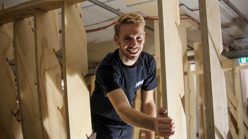 Architect Thomas Wing-Evans inside the wooden structure.