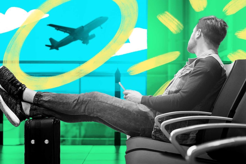 Man at airport lounge with feet up on suitcase staring out the window at a plane is taking off to depict how to combat jet lag.