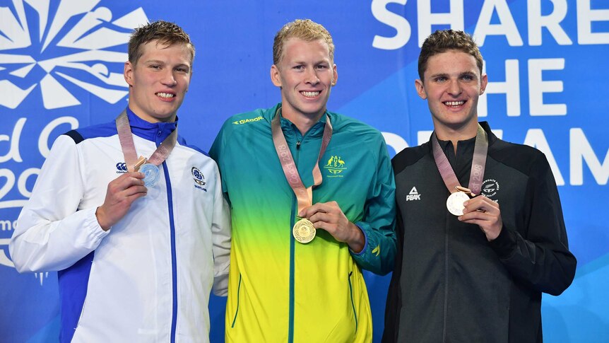 Silver medalist Mark Szaranek, gold medalist Clyde Lewis of Australia and bronze medalist Lewis Clareburt stand on the podium.