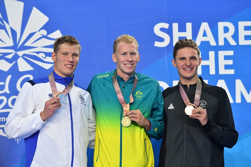 Silver medalist Mark Szaranek, gold medalist Clyde Lewis of Australia and bronze medalist Lewis Clareburt stand on the podium.