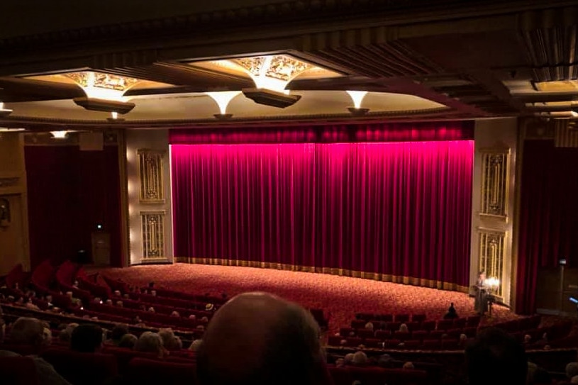 A large red curtain covering a stage 