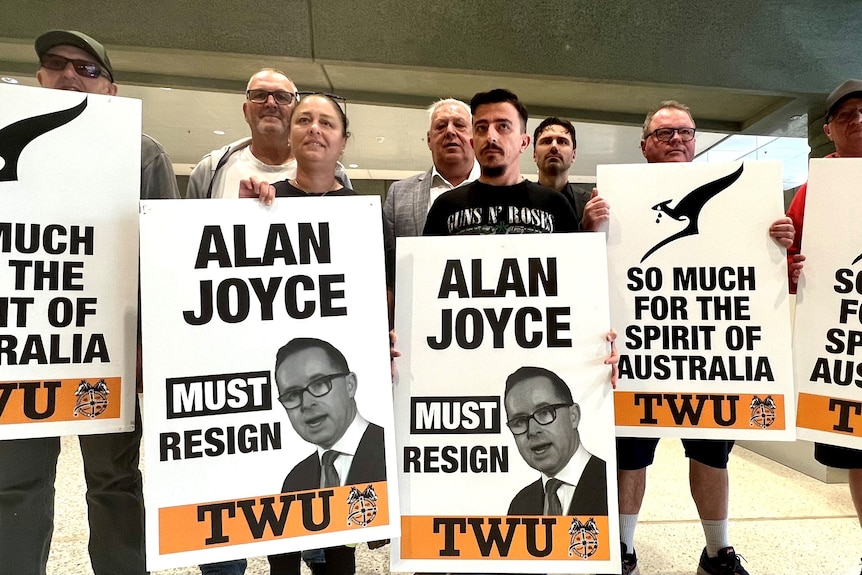 People protest against Qantas boss Alan Joyce at Sydney airport