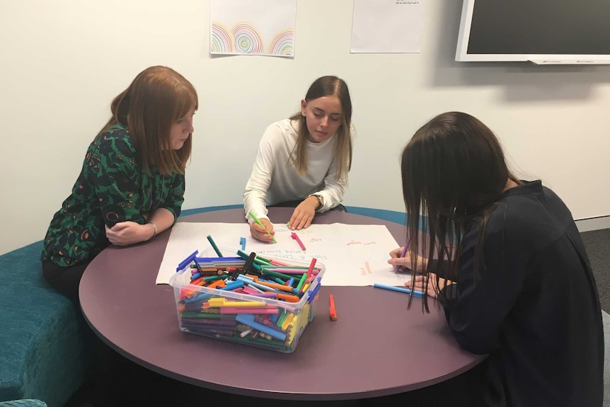 Anorexia employees at a table with Butterfly Foundation employees for a counselling session