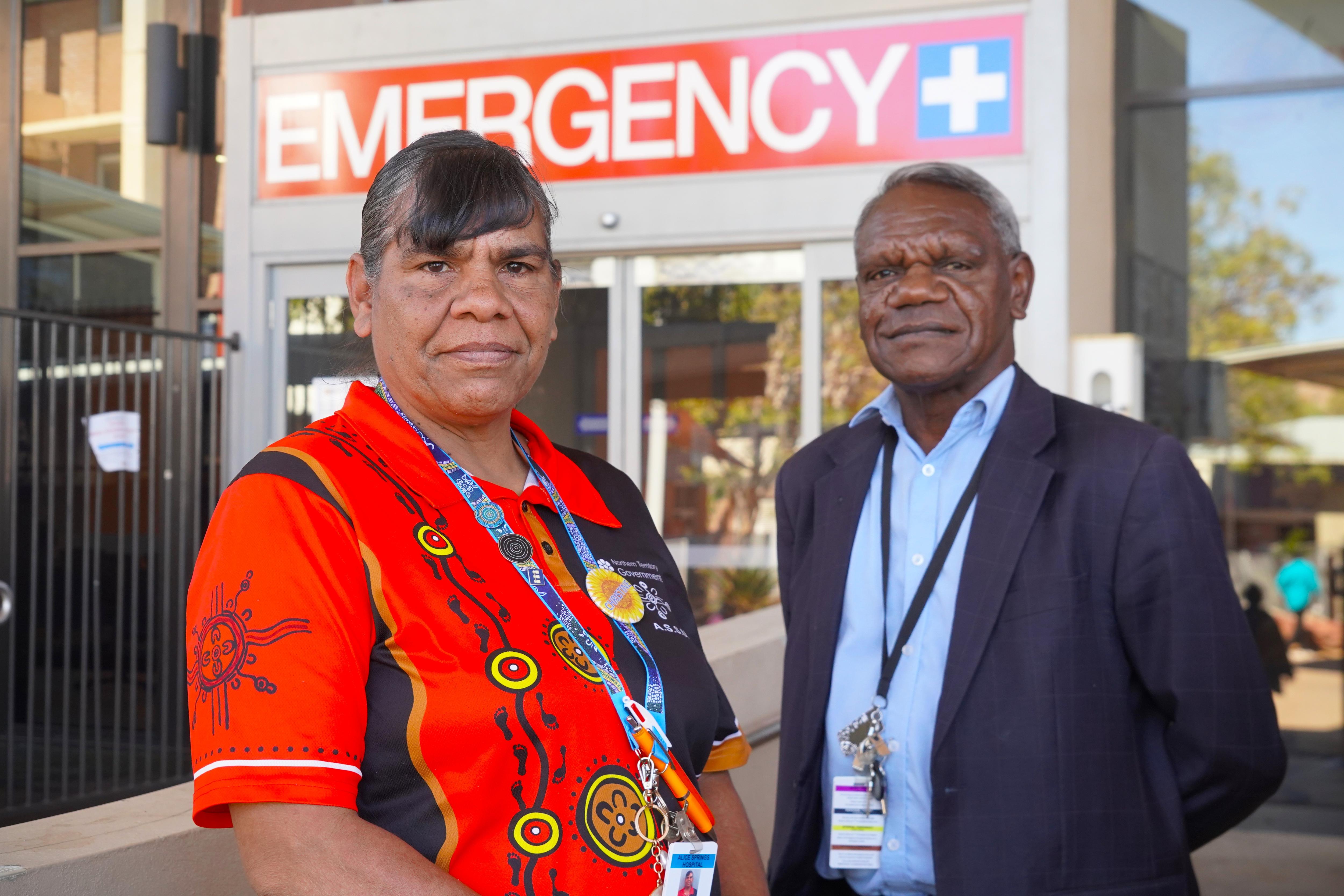 An Aboriginal woman and man stand out of the front of an emergency department
