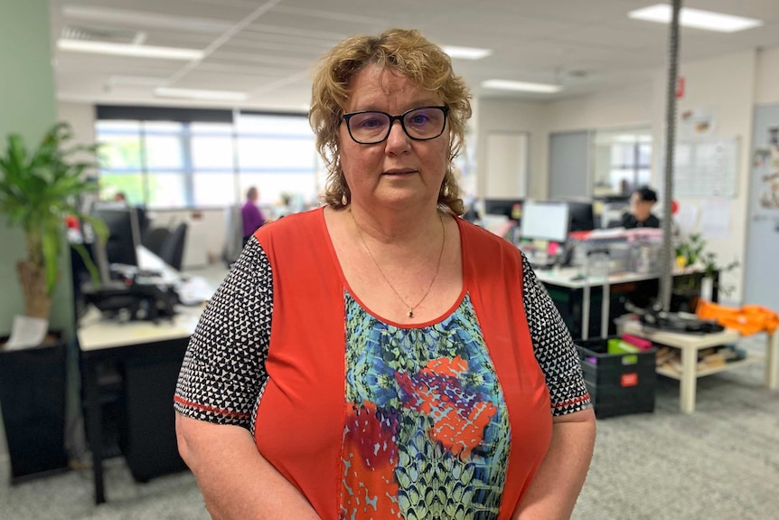 Micah Projects CEO Karyn Walsh stands in an office.