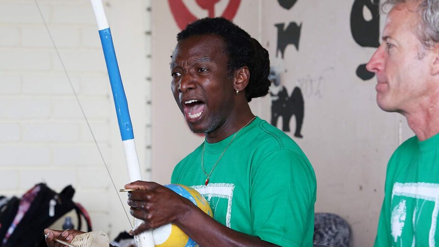 Mestre Roxinho guides the group, teaching the movement, songs and dance of Capoeira Angola.