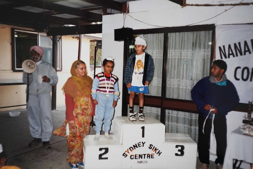 L-FRESH as a child standing on a medal podium at the Sydney Sikh Centre in Parklea.